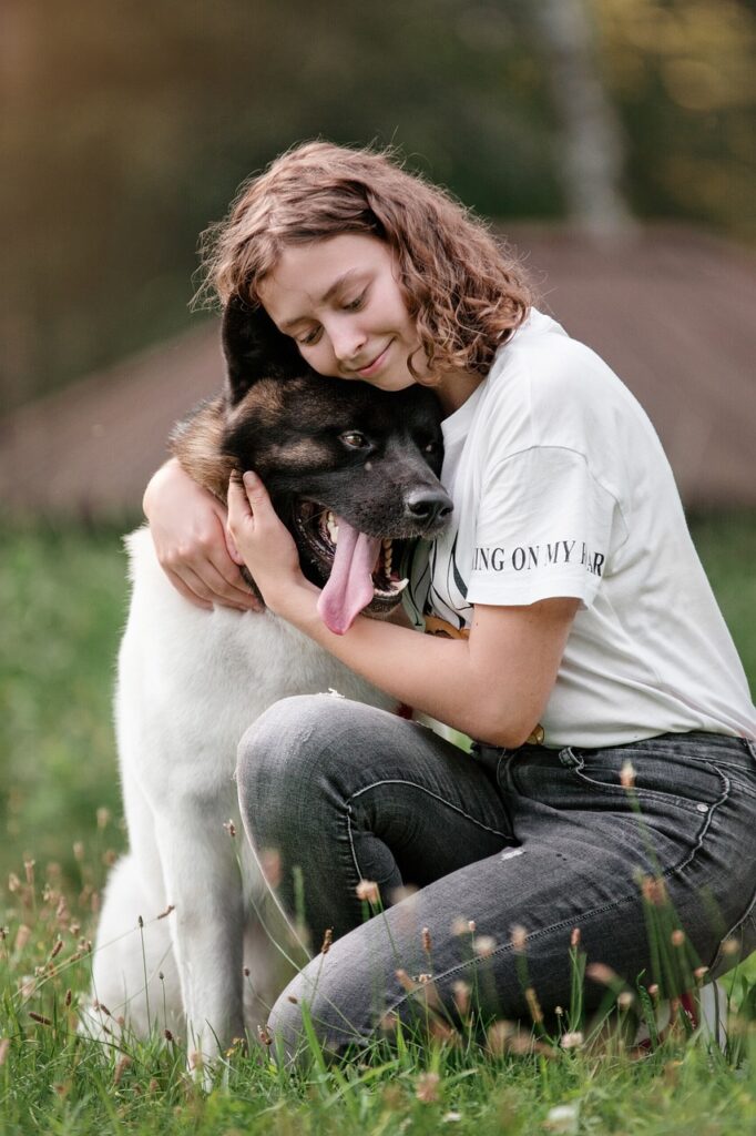 A woman hugs her dog.